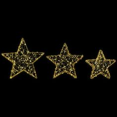 three gold stars are shown against a black background, with the light shining on them