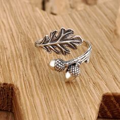 Beautiful sterling silver leaf and acorn adjustable ring. This beautiful sterling silver adjustable oak leaf and acorn ring represents strength and longevity, and can remind us of our humble beginnings. The life-like details - from the hatchmarks on the shell to the texture on the branch band - make this ring a special find, especially in the autumn season. Oak trees start life as an acorn, and can take centuries to become the mighty oak tree of legendary status.   As with all our adjustable rin Silver Leaf-shaped Adjustable Jewelry, Silver Leaf-shaped Ring As Gift, Silver Leaf Ring As Gift, Silver Leaf Ring Gift, Adjustable Silver Leaf Jewelry, Acorn Ring, Witch Fairy, Silversmithing Jewelry, Fall Nature