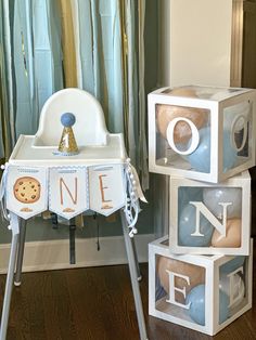 a baby's first birthday gift set up in front of a chair and table