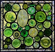 a stained glass window with many different colors and designs on it's sides, including circles