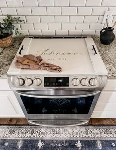 a stove top oven sitting on top of a counter next to a potted plant