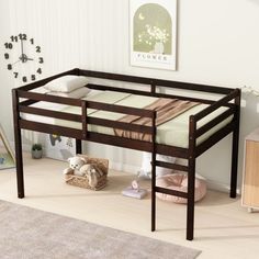 a wooden bunk bed sitting on top of a hard wood floor next to a rug