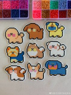 cross stitch animal stickers are displayed in front of some crafting supplies and beads