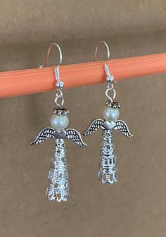 Long Angel Earrings tell a Christian message and are perfect for Christmas! Choose silver, gold or antique gold, and choose white or beige pearls. Angel skirt bodies can be rotated to best position. Gift box available. Indicate Item 0052 and color choices. Angel Skirt, Christmas Angel Crafts, Florida Christmas, Beaded Angels, Christmas Message, Angel Earrings, Angel Crafts, Christmas Messages, Christian Christmas