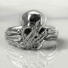 Discover the allure of the Personalized Silver Skull Ring, a handcrafted masterpiece that embodies the essence of gothic elegance and biker spirit. This ring captivates with its intricate, realistic design, promising to become a treasured piece in any collection. Crafted from high-quality silver, this ring symbolizes Memento Mori and Amor Fati, reminding its wearer of the beauty in life and fate. You will appreciate the attention to detail and this ring's unique statement. Ring Detail: Metal Hig Chrome Hearts Jewelry, Hip Hop Rings, Handmade Skulls, Silver Skull Ring, Biker Rings, Skull Face, Skull Jewelry, Personalized Pendant, Skull Ring