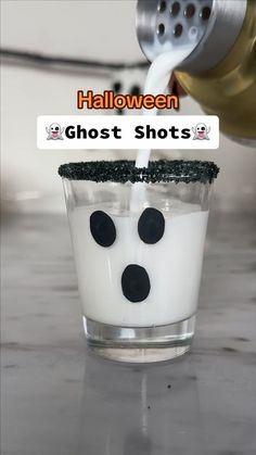 a glass filled with milk sitting on top of a counter