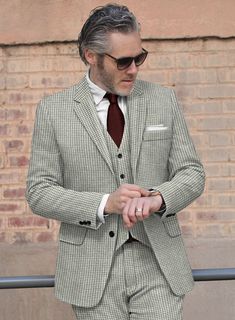 The semblance of a person sometimes is identified by the fashion one chooses to be different from everyone else. Tailored with wool, our Houndstooth Light Gray Tweed Suit is a piece with a houndstooth pattern which is a unique design that looks like a hound dog's tooth and gives warmth at every wear. In addition, the light gray color will emanate your personality giving positive vibes. So include this excellently designed suit in your closet, which will create a trend that will never go out of style.  Look Includes   Houndstooth Light Gray Tweed Fabric  Two Button Jacket Style  Notch Lapel  Real Horn Royal Buttons  Single Vent  Three Cuff Buttons  Two Welted Back Pockets on Trousers    Click 'Customize Now' to modify the look if needed.   Lining: Viscose; Dry Clean. Tweed Blazer With Houndstooth Pattern, Tailored Tweed Blazer With Houndstooth Pattern, Tailored Houndstooth Suit For Fall, Tweed Jacket With Houndstooth Pattern For Business Casual, Wool Houndstooth Suit With Suit Collar, Classic Houndstooth Suits For Winter, Tailored Wool Suit With Houndstooth Pattern, Formal Wool Houndstooth Tweed Jacket, Classic Wool Tweed Jacket With Houndstooth Pattern