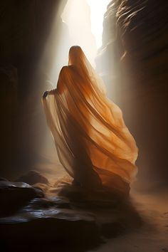 a woman in an orange dress is walking through a cave with light coming from behind her