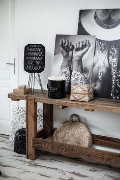 a wooden table topped with pictures next to a basket and other items on top of it