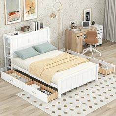 a white bed with drawers underneath it in a bedroom next to a desk and chair