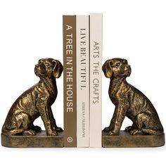 two golden dog bookends sitting next to each other