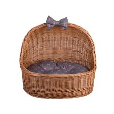 a wicker dog bed with a bow tie