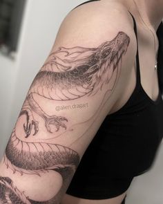 a woman with a dragon tattoo on her arm