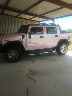 a pink hummer truck parked in a garage