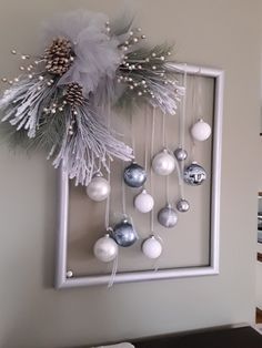 a white frame with ornaments hanging on it