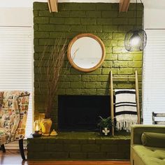 a living room filled with furniture and a green brick fire place in the middle of it