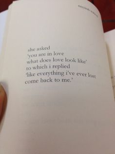 someone is holding an open book in their hand with the words she asked you are in love what does love look like to which i replaced like everything i've ever lost one back to me