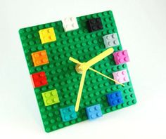 a clock made out of legos on a white surface