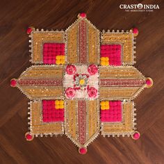 an intricately designed rug with flowers and beads on the floor in front of a wooden floor