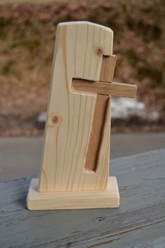 a wooden sculpture with a piece of wood sticking out of it