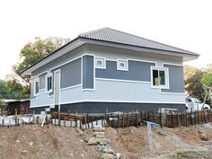 a house is being built on the side of a hill