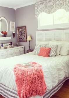 black and white photograph of a bedroom with bed, dressers, mirror and window