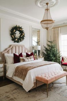 a bedroom with a large bed and a chandelier hanging from the ceiling