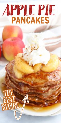 a stack of pancakes topped with whipped cream and apples on a white plate next to an apple