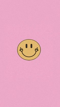 a pink background with a smiley face drawn on it