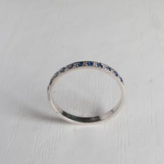 A perfect Marriage of Sapphires and Gold metal (Also Silver). Handmade with maximum attention to detail This half eternity ring has both the reserved class you would except from such a ring As well as the Sparkle that will have you looking down at your finger constantly. Its dainty and Perfect for Stacking with other rings. Made to last solid Silver or Gold with attention comfort built into every aspect of this ring. Set with 11 Blue Sapphires. Ring Shown in pictures is 14 Karat White Gold , Rho Sterling Silver Sapphire Half Eternity Ring As Gift, Silver Multi-stone Sapphire Ring In Fine Jewelry Style, Classic White Gold Sapphire Ring Half Eternity, Silver Sapphire Half Eternity Ring, Sterling Silver Multi-stone Sapphire Ring In White Gold, Perfect Marriage, Half Eternity Ring, Eternity Ring, Rhodium Plated