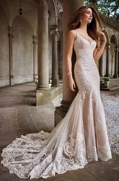 a woman in a wedding dress standing on steps