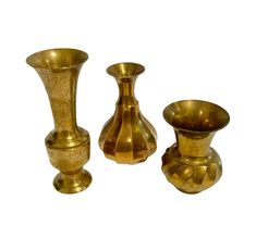 three brass vases sitting next to each other