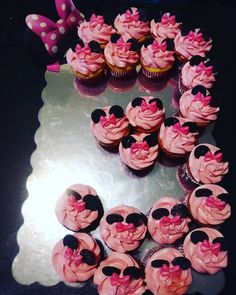 cupcakes with pink frosting and minnie mouse decorations