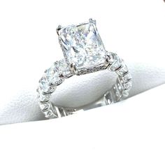 a white gold ring with a princess cut diamond