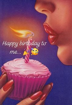 a woman holding a cupcake with a lit candle on it's top that says happy birthday to me