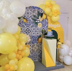 balloons and decorations are displayed in front of a backdrop for a lemon themed birthday party