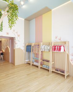 the interior of a children's clothing store with wooden floors and walls painted in pastel colors