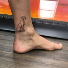 a small dog tattoo on the ankle