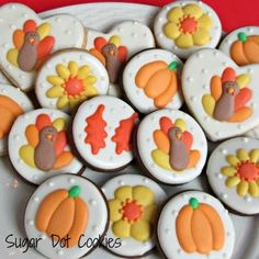 some decorated cookies are on a plate and ready to be used for thanksgiving dinneres