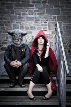 two people sitting on some steps with one person dressed as a demon and the other wearing a devil mask