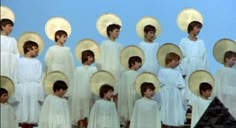 a group of young men standing next to each other in front of white umbrellas