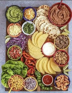 a platter filled with tacos, guacamole and tortilla chips