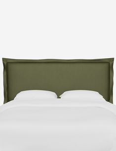 an upholstered headboard on a bed with white linens and green pillows