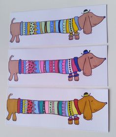 three stickers with dachshunds wearing sweaters