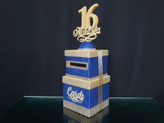 a blue and gold box with the number sixteen on it's top is shown in front of a black background