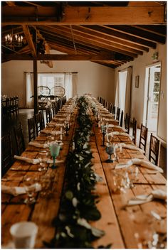 the long table is set with place settings