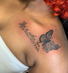 a woman with red hair has a butterfly tattoo on her chest and is wearing a face mask