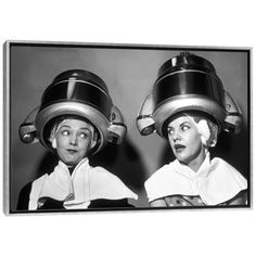 black and white photograph of two women with helmets on their heads