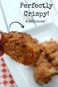 a person is holding up some food on a plate with the words perfectly crispy and delicious