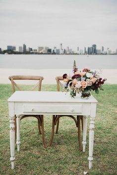 two chairs and a table with flowers on it